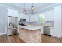 Modern kitchen featuring stainless steel appliances and a granite island at 803 W Sligh Ave, Tampa, FL 33604