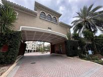 Building entrance with brick driveway and landscaping at 501 Knights Run Ave # 1327, Tampa, FL 33602