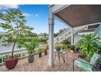 Ground level patio overlooking the water with lush plants at 5176 Salmon Se Dr # A, St Petersburg, FL 33705