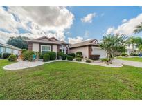 Single-Gathering home with well-maintained lawn, landscaping, and paver driveway at 739 Winterbrooke Way, Sun City Center, FL 33573