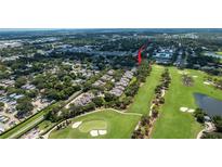 Beautiful community aerial view shows golf course, nearby homes, and mature landscaping at 9 Pelican Pl, Belleair, FL 33756