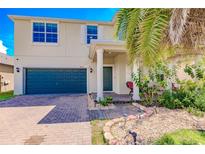 Two-story house with a brick driveway and landscaped yard at 10215 Count Fleet Dr, Ruskin, FL 33573