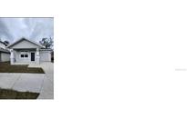 Charming single-story home with well-maintained landscaping and attached one car garage at 2404 1/2 E Chelsea, Tampa, FL 33610