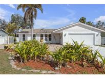 Charming single-story home features lush landscaping and a beautiful palm tree in the front yard at 8002 Lake Dr, Palmetto, FL 34221