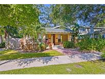 Charming bungalow with a covered porch and lush landscaping at 5700 N Suwanee Ave, Tampa, FL 33604