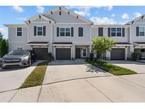 Three-unit townhome building with parking and landscaping at 10985 Brightleaf Ct, Riverview, FL 33569
