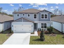 Charming two-story home with an attached two-car garage and well-maintained landscaping in a suburban neighborhood at 4285 Big Sky Dr, Spring Hill, FL 34604