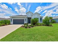 Two-story house with gray siding and landscaping at 13769 Old Creek Ct, Parrish, FL 34219