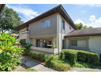 Condo building with landscaping and walkway at 2935 Lichen Ln # C, Clearwater, FL 33760