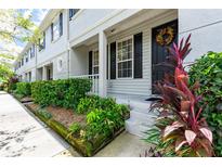 Townhome exterior with landscaping and black shutters at 34846 Teeview Ln, Zephyrhills, FL 33541