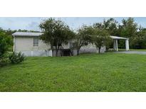 Single-story home with covered porch and large yard at 17889 Thomas Blvd, Hudson, FL 34667