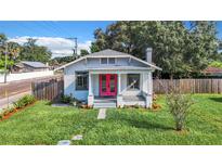 Charming bungalow with a bright pink front door and well-manicured lawn at 211 W North Bay St, Tampa, FL 33603