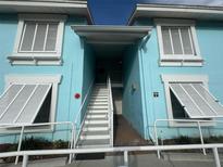 Bright blue building exterior with white stairs and railings at 3730 42Nd S Way # H, St Petersburg, FL 33711