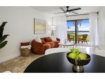 Bright living room with water view, featuring comfortable couch and decor at 6291 Bahia Del Mar Cir # 103, St Petersburg, FL 33715