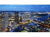 Aerial view of Tampa, FL, at night, showing the city skyline and waterfront at 111 S Ashley Dr # 1907, Tampa, FL 33602