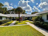 Community courtyard with lush landscaping and walkways at 2753 Countryside Blvd # 105, Clearwater, FL 33761