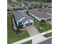 Aerial view of single Gathering home with driveway and landscaping at 4134 Montegrappa Way, Wesley Chapel, FL 33543