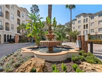 Community entrance with a fountain and lush landscaping at 501 Knights Run Ave # 1215, Tampa, FL 33602