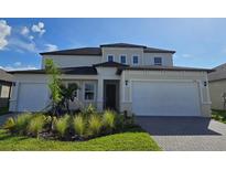 Two-story house with a three-car garage at 7045 E 113Th Ct, Palmetto, FL 34221