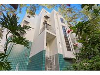 Modern building with teal tile accents and lush landscaping at 4950 Bayshore Blvd # 13C, Tampa, FL 33611
