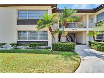 Condo building exterior showcasing landscaping and walkway at 4600 Marine Parkway # 104, New Port Richey, FL 34652