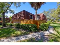 Two-story townhome with brown tile roof at 2713 4Th Ct, Palm Harbor, FL 34684