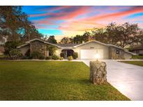 Stunning ranch-style home with stone accents, and a gated entry at 4540 Lake In The Woods Dr, Spring Hill, FL 34607