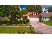 House with a red accented gable and a two car garage at 2011 Green Juniper Ln, Brandon, FL 33511