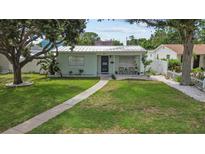 Charming light green house with a well-maintained lawn at 6810 4Th N Ave, St Petersburg, FL 33710