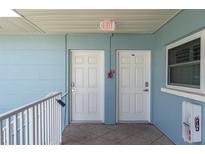 Clean hallway with white doors and fire safety equipment at 6000 2Nd E St # 6, St Pete Beach, FL 33706