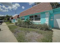 Exterior of a light teal colored house with a garage at 7081 Lafayette N # 7081, Pinellas Park, FL 33781