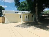 Charming single-story home with a covered front porch and light yellow exterior at 1155 7Th N St, Safety Harbor, FL 34695