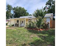Charming single-story home with a well-maintained front yard and covered porch at 1155 7Th N St, Safety Harbor, FL 34695