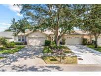 Attractive exterior of a single-story home with a two-car garage and lush landscaping at 2989 Brookfield Ln, Clearwater, FL 33761