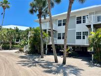 Two-story beachfront home with parking and tropical landscaping at 7530 Palm Island S Dr # 1413, Placida, FL 33946