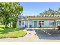 Light blue house with carport and well-manicured lawn at 2222 Greenhaven Dr, Sun City Center, FL 33573