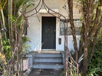 Quaint house exterior with black front door and garden at 2001 15Th S Ave, St Petersburg, FL 33712