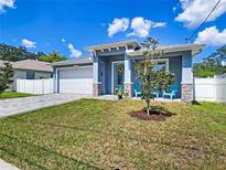 Newly built home with attached garage and landscaped lawn at 2115 W Idlewild Ave, Tampa, FL 33603