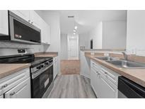 Modern kitchen with stainless steel appliances and light wood cabinets at 18001 Richmond Place Dr # 511, Tampa, FL 33647