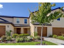 Two-story townhome with attached garage and landscaping at 5377 Companion Ln, Tampa, FL 33619