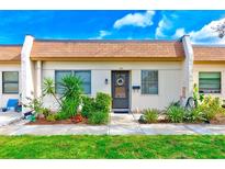 Exterior view of a condo with landscaped garden at 1619 Mission Hills Blvd, Clearwater, FL 33759