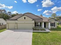 Two-story house with two-car garage and landscaping at 4013 Chadwick Ave, Spring Hill, FL 34609
