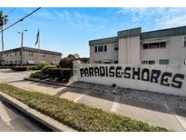 The entrance to Paradise Shores community, featuring a large sign and landscaping at 5286 81St N St # 4, St Petersburg, FL 33709