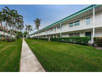 Exterior of a condo building with walkway and landscaping at 5217 81St N St # 11, St Petersburg, FL 33709