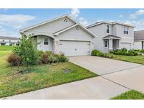 Two-car garage and front yard landscaping at 3516 Maple Grove Way, Plant City, FL 33565