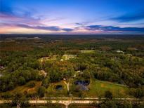 Wide aerial view of expansive property at sunset at 655 Appaloosa Rd, Tarpon Springs, FL 34688