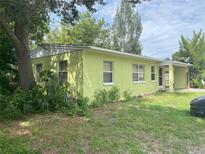 Ranch style home with light green exterior and yard at 1528 Stevensons Dr, Clearwater, FL 33755