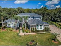 Two-story home with stone accents and landscaped yard at 180 Keystone Palms Blvd, Tarpon Springs, FL 34688