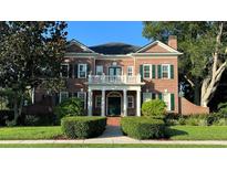 Brick home with columns and manicured hedges at 29731 Chapel Park Dr, Wesley Chapel, FL 33543