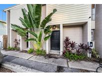 Modern building exterior with lush tropical landscaping and electric vehicle charging station at 1905 E Mulberry Dr # 1, Tampa, FL 33604